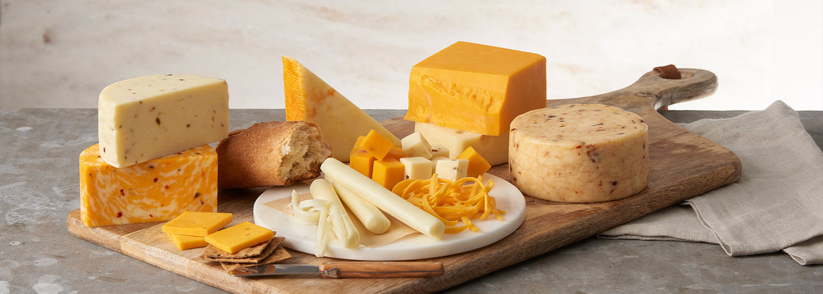 Variety of cheeses on a wooden cutting board